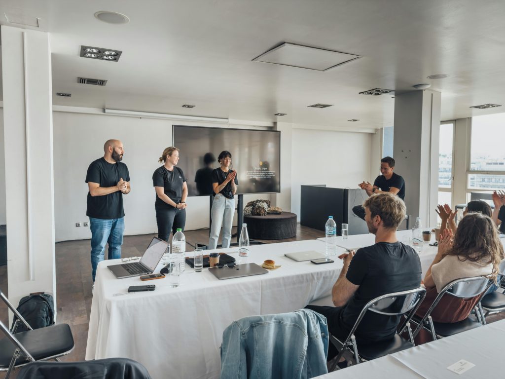 pexels-photo-15141213-15141213 Team presenting ideas in a modern office with attentive audience and tech equipment.
